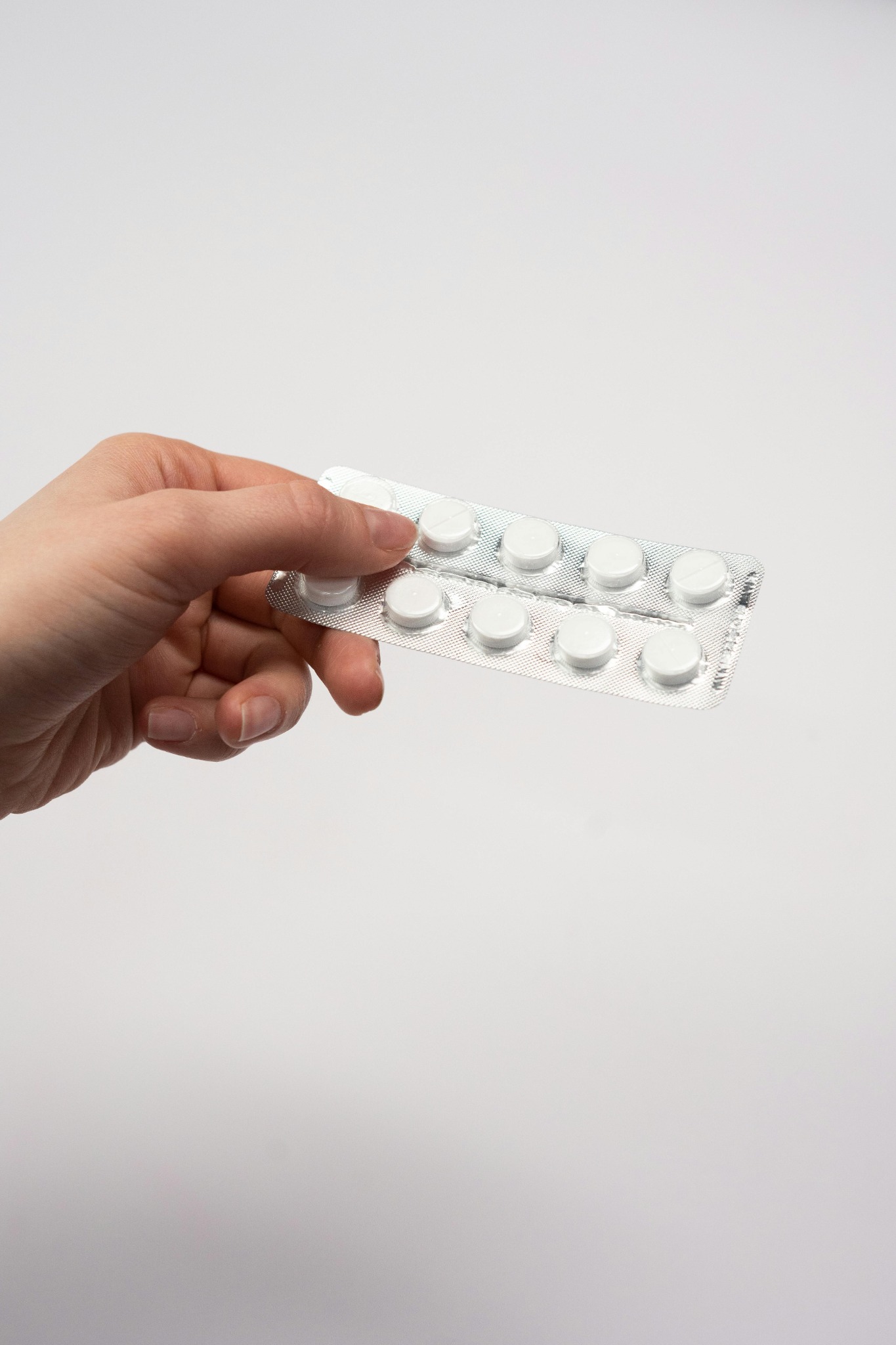 Medication blister pack representing review of treatment response and routine health follow-up.